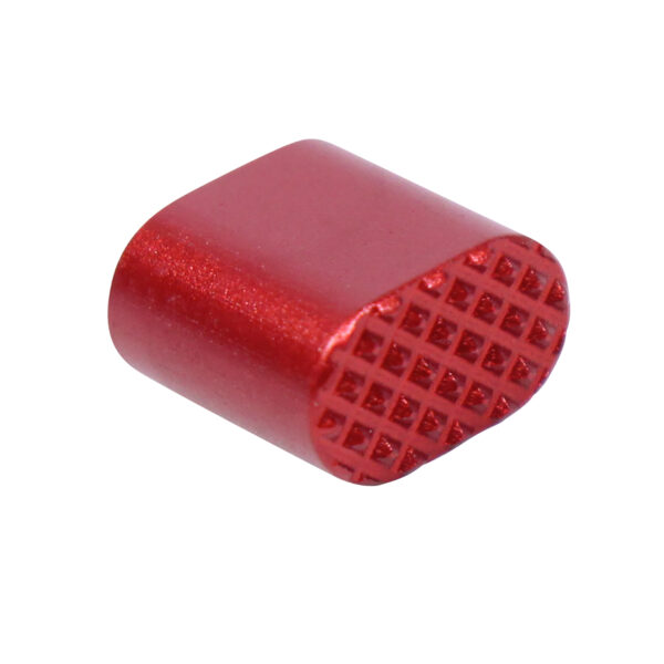 Red cylindrical button with textured end for gripping or pressing.