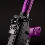 Modern tactical rifle with purple accents and advanced rail system.