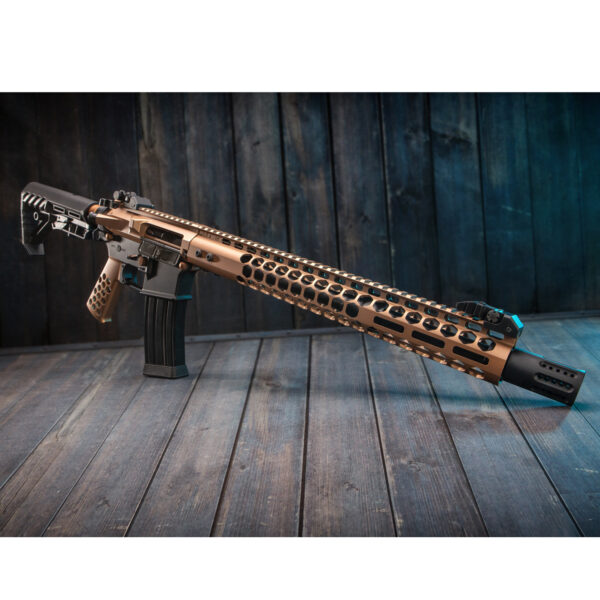 Bronze tactical rifle on rustic wooden floor with adjustable stock and muzzle brake.