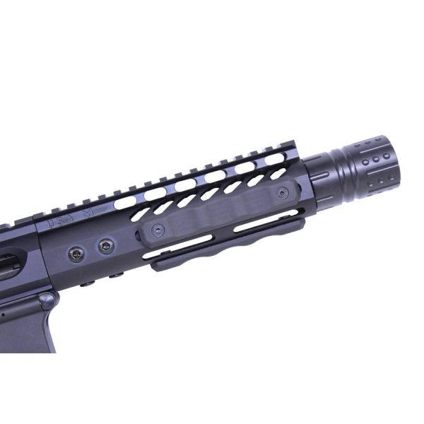 Close-up of AR-style rifle with M-LOK grip panels and Picatinny rail system.