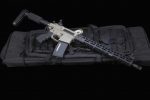 Modern AR-style rifle with tan finish and black M-LOK handguard on a dark background.