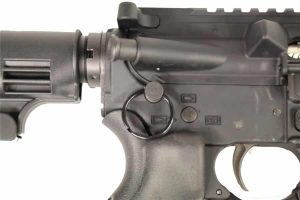 Close-up of AR-15 lower receiver focusing on trigger assembly and safety selector.