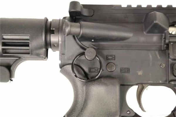 Close-up of AR-15 lower receiver focusing on trigger assembly and safety selector.