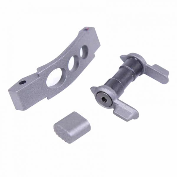 Precision-machined AR-15 trigger parts: bracket, pivot pin, spacer in matte gray metal.