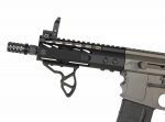 Close-up of tactical AR-15 upper with Picatinny rail and compact muzzle device.