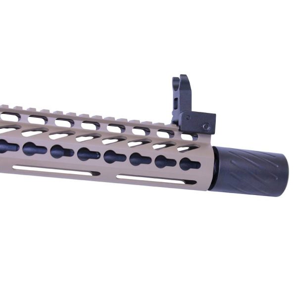 Modern AR rifle close-up with tan M-LOK handguard, black muzzle device, and front sight post.