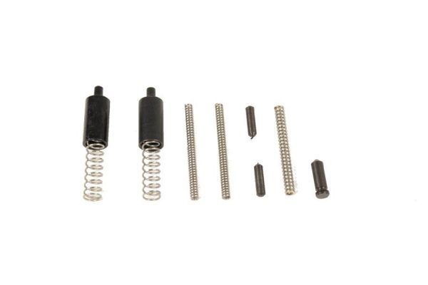 AR-15 assembly springs and pins on white background, showcasing firearm components arrangement.