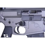 Close-up of AR-15 lower receiver with trigger assembly and safety selector in gray aluminum.