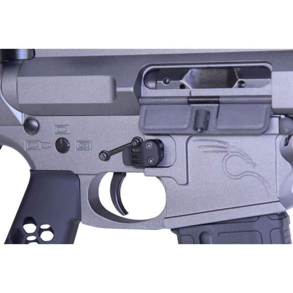 Close-up of AR-15 lower receiver with trigger assembly and safety selector in gray aluminum.