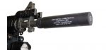 Close-up of firearm barrel with black suppressor showcasing sleek, precision engineering and noise reduction.