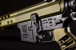 Close-up of tan AR-15 rifle showcasing precision engineering and design details.