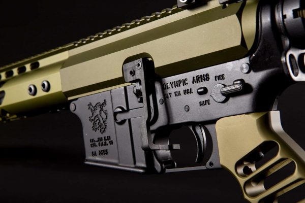 Close-up of tan AR-15 rifle showcasing precision engineering and design details.