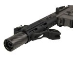Close-up of a fluted rifle barrel showcasing spiral design and tactical features.