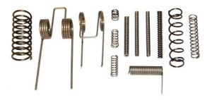 Assorted metal springs and coils on white background, displaying various sizes and mechanical designs.