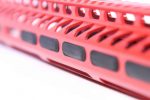 Guntec USA red anodized firearm rail with ventilation slots and accessory attachments.