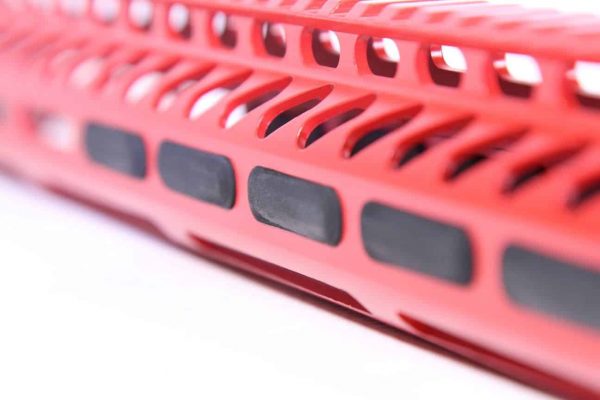 Guntec USA red anodized firearm rail with ventilation slots and accessory attachments.