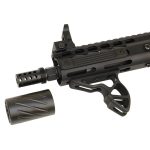 Close-up of modular black tactical rifle with rail system and detachable muzzle device.
