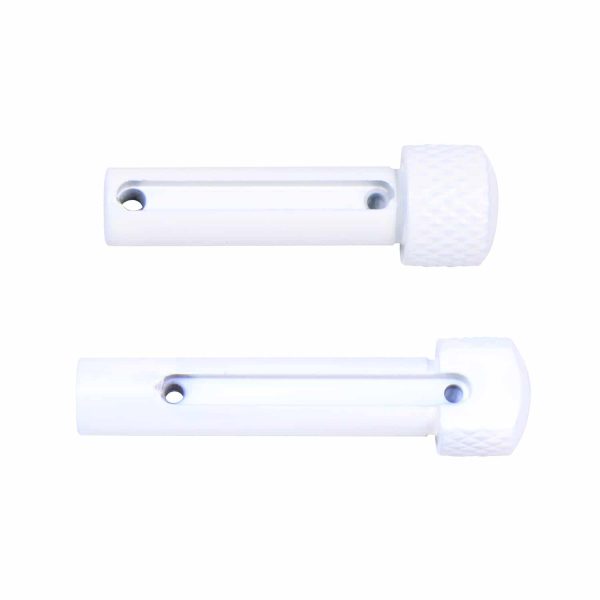 White plastic cabinet fasteners with mounting holes and circular knob for home use.