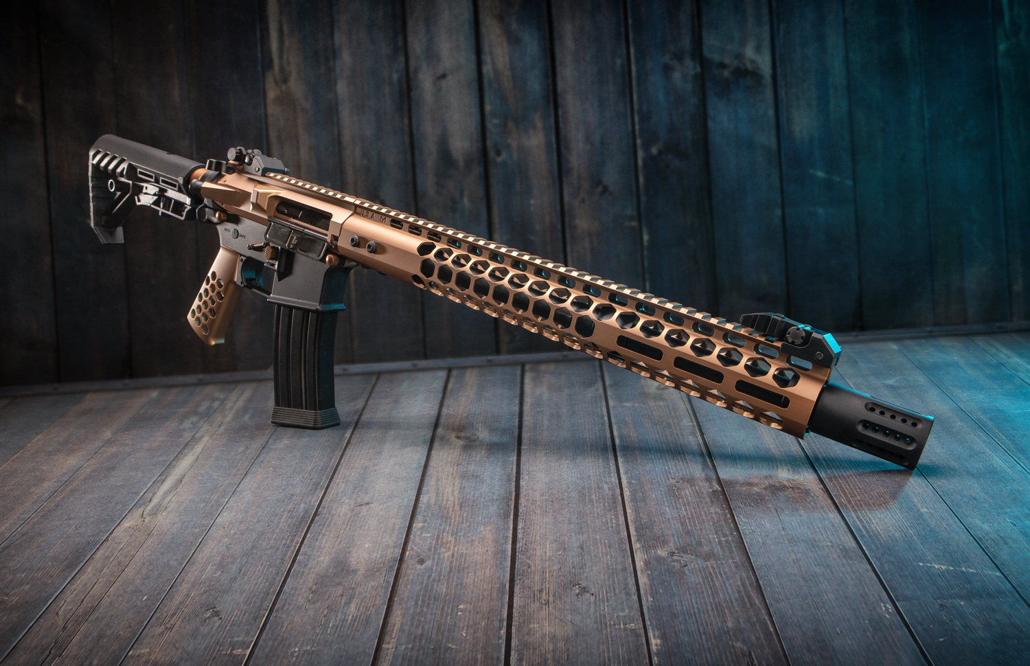 AR-9mm rifle with bronze ultimate kit against a rustic wooden backdrop.