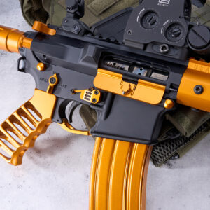 Custom orange and black rifle with skeleton grip and advanced optics.