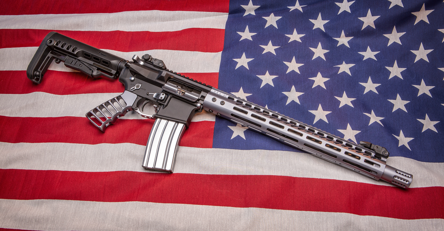 Modern AR-9mm rifle on American flag, symbolizing advanced gun design and patriotism.