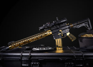 Gold-plated rifle with advanced scope and tactical case, showcasing luxury and precision.