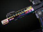 Close-up view of GT-7MLK-RPVD pistol with rainbow PVD finish and intricate handguard design.