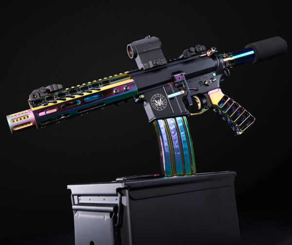 Colorful iridescent AR-15 rifle with tactical optics on a dark stand.