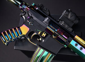 Iridescent rifle with tactical scope on dark surface, showcasing vibrant, reflective finishing.