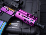 Custom purple GT-4MLK handguard on pistol with rainbow magazine, on Pelican 1400 case.