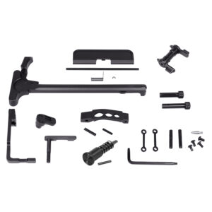 Assorted mechanical parts for assembly kit on plain background.