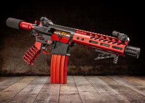 Custom AR-15 rifle with red and black anodized upper receiver kit.