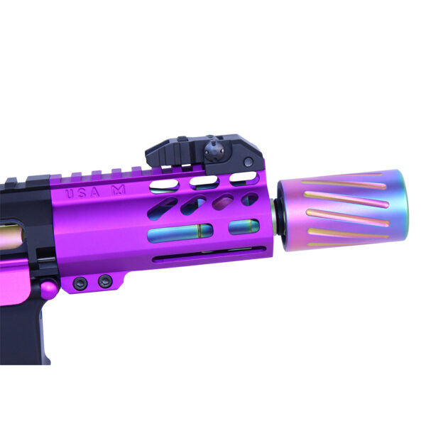 Close-up of an AR-15 muzzle comp with a detachable blast shield in rainbow PVD coating.