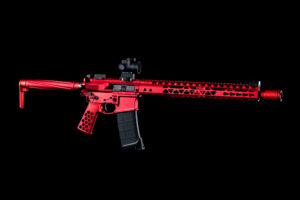 Striking red tactical rifle with modern design and Picatinny rails on a black background.