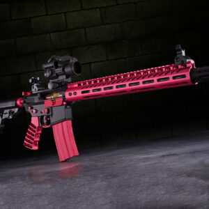 Pink and black tactical rifle with advanced optics on a reflective surface.