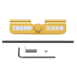 Gold AR-15 dust cover with TRUMP 2024 text and assembly kit components.