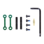 Complete AR-15 anti-rotation pin set in anodized Irish green with tools and components.
