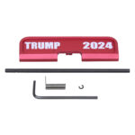 AR-15 red ejection port cover with TRUMP 2024 engraving and assembly tools.