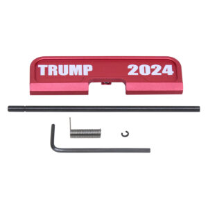 AR-15 red ejection port cover with TRUMP 2024 engraving and assembly tools.