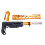 Vivid gold AR-15 rifle parts: handguard, stock, buffer tube, spring; product-style display.